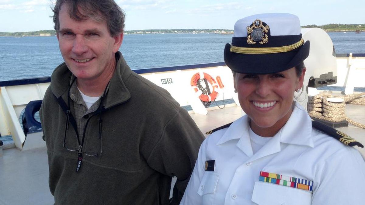 In this Saturday, June 13, 2015 file photo Michael Hurley, a South Carolina author who lost his storm-battered sailboat on a failed Atlantic crossing, left, poses for a photo with Maine Maritime Academy junior Gabrielle Wells on the stern of the training vessel State of Maine, in Portland, Maine. The novelist who lost his 30-foot sailboat on an Atlantic crossing drew inspiration from his rescue in his new book.
