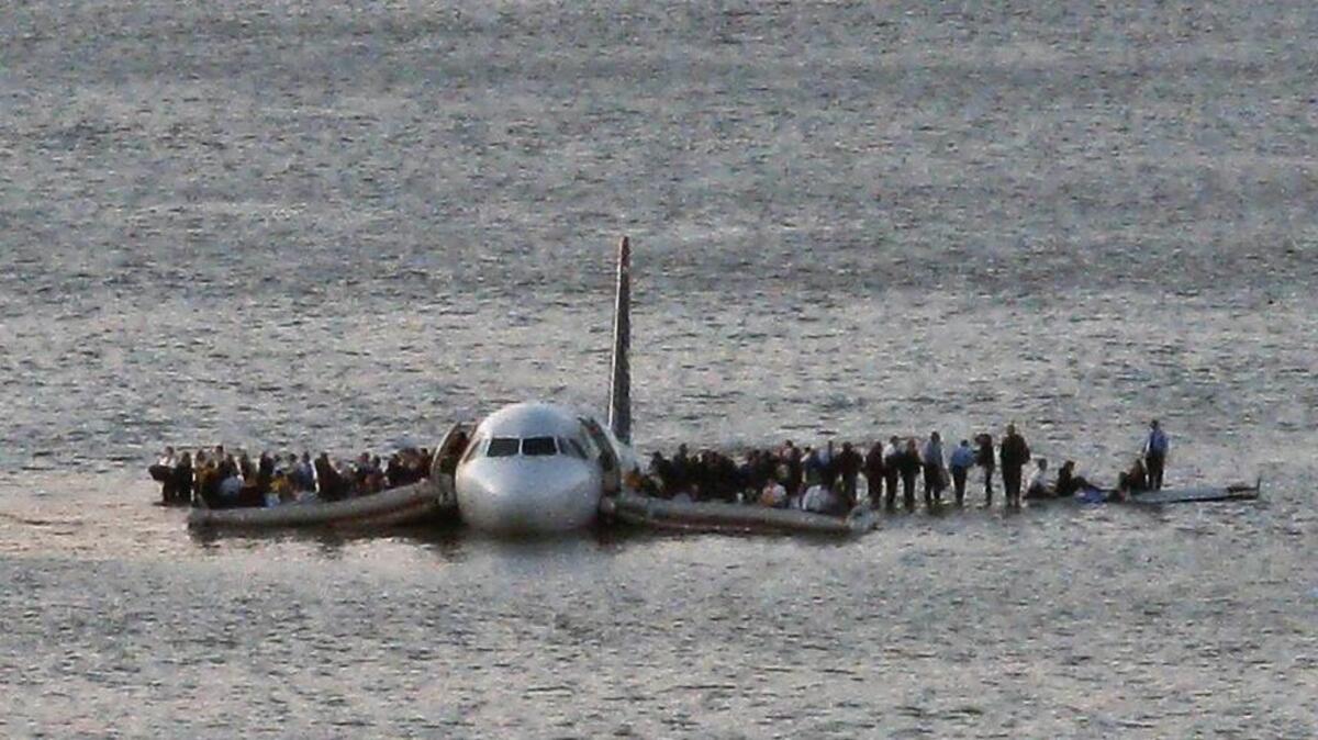 Passengers wait to be rescued Jan. 15, 2009, from the wings of a US Airways jetliner that was safely ditched in the Hudson River in New York.