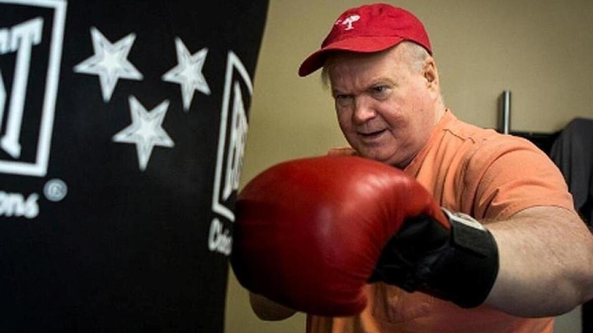 Pat Conroy works out at the fitness studio he opened as part of his makeover. In three years, he has lost 25 pounds, quit drinking, brought his blood pressure down and improved his diet.