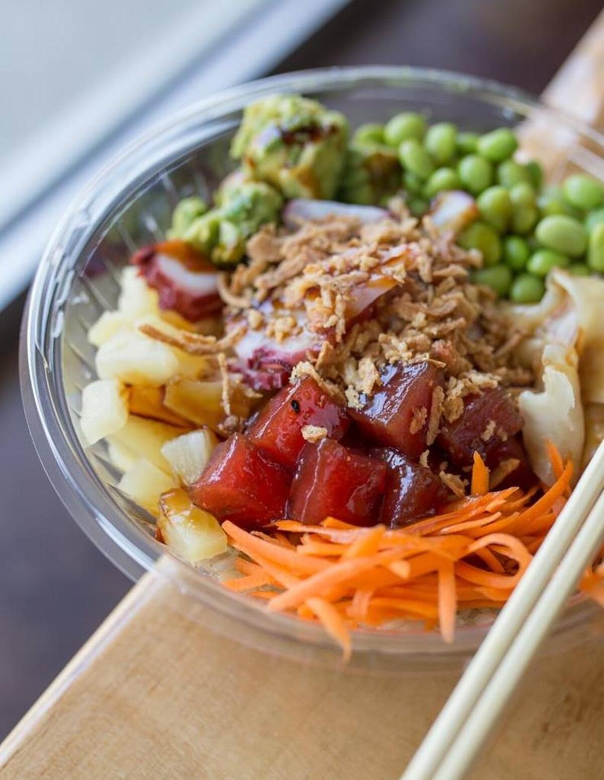 Custom poke bowls at Poke Bros. may include shrimp, salmon, ahi tuna, seaweed, sweet onion, cucumbers, edamame and more.