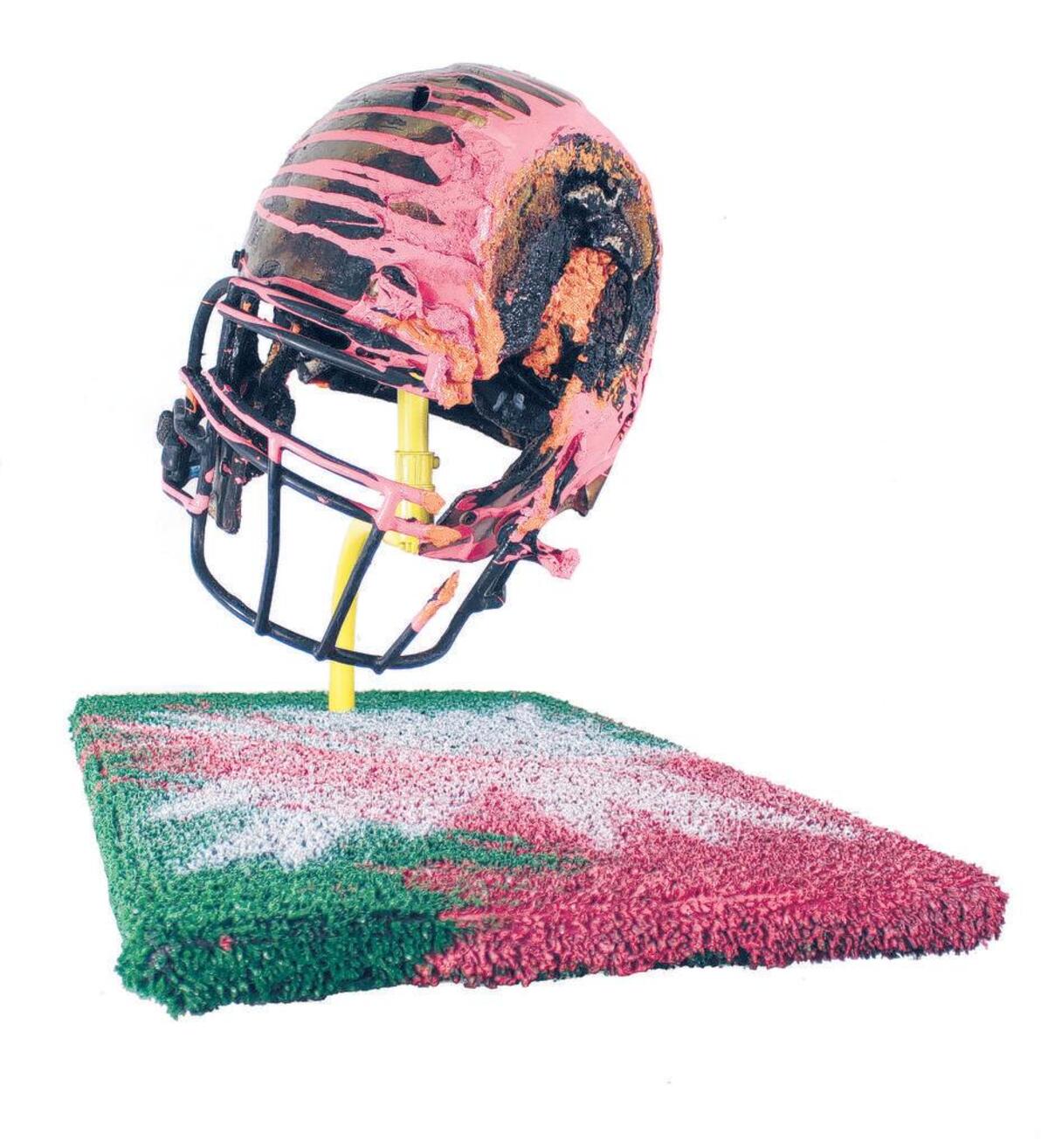 “Blow-out” from 2017 is made from a helmet, metal pipe, wood, latex paint, Astroturf and polyurethane.