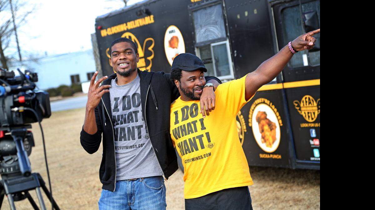 
Corey Simmons, left, and Ramone Dickerson, of 2 Fat 2 Fly will be at the South Carolina Food Truck & Craft Beer Festival Sunday at the SC State Farmers Market. 
