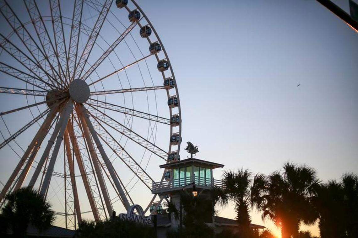 The sun rises behind the Myrtle Beach SkyWheel.