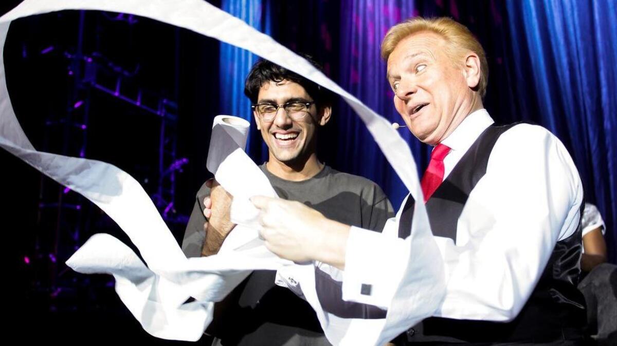 Jeff Hobson performs a trick during “The Illusionists.” Below, Andrew Basso performs an escape.