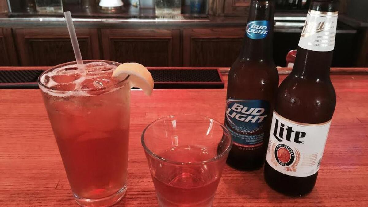 
Drinks at Wild Wing Cafe in the Vista, from left, include Sweet Victor-Tea, Sour Loser Shot and bottles of Bud Light and Miller Lite.
