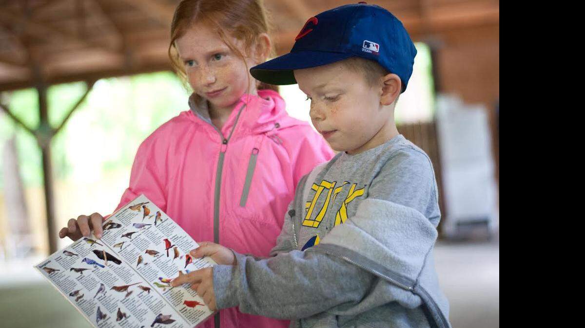 
Ella Munn, 7, and her brother, Chaz Munn, 5, from Charlotte, talk birds at Riverbanks Zoo Saturday morning during the zoo’s “Party For the Planet” celebration honoring Mother Earth. Interactive educational activities included, among others, a poster contest, animal bingo, temporary tattoos, and making jewelry out of plastic bags.
