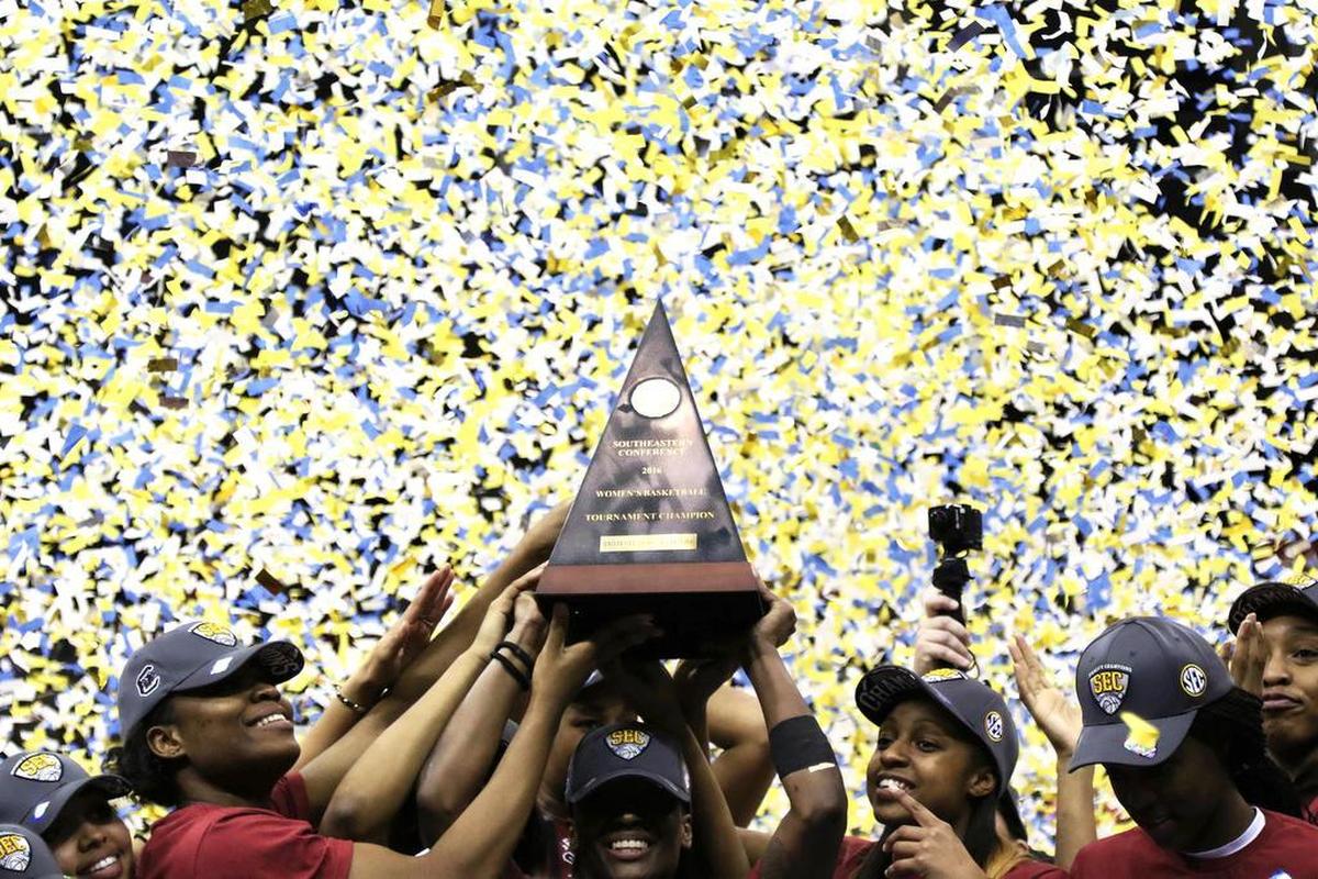 The South Carolina Gamecocks hold women’s SEC basketball tournament champion trophy