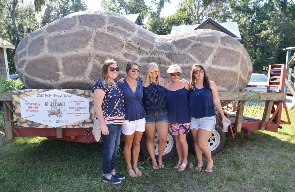 A group poses with the world's largest boiled peanut at last year's Boiled Peanut Festival in Bluffton.