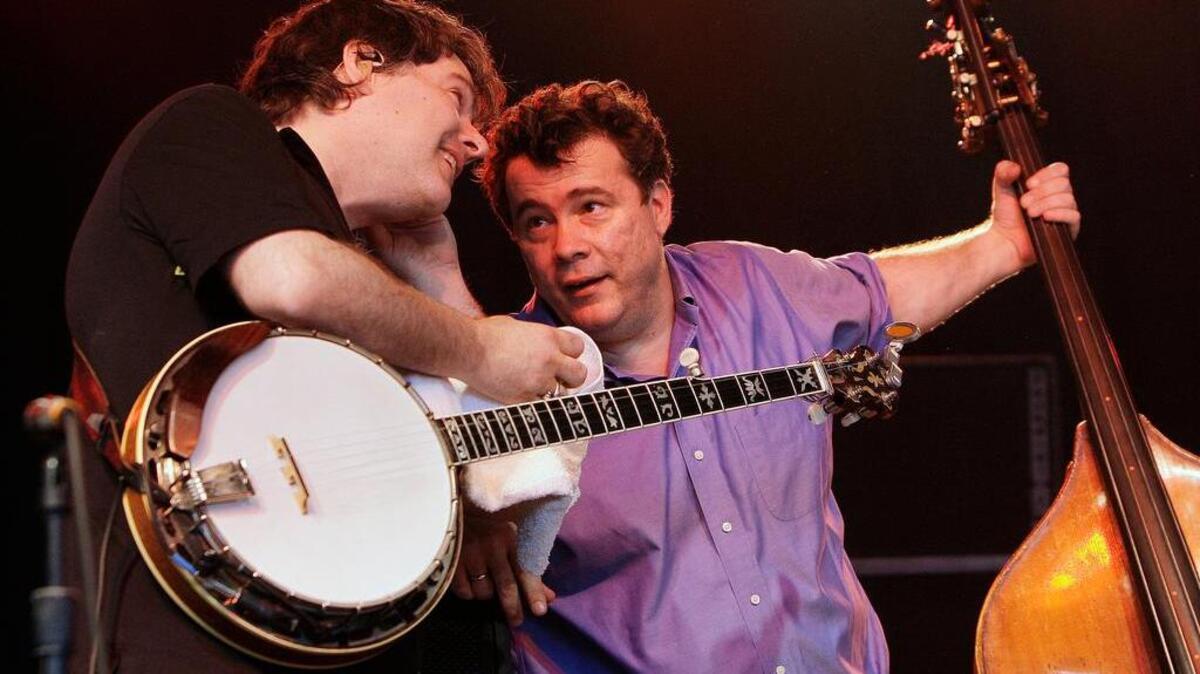 Banjo player Bela Fleck, left, talks with bass player Edgar Meyer, right, during a 2008 performance.