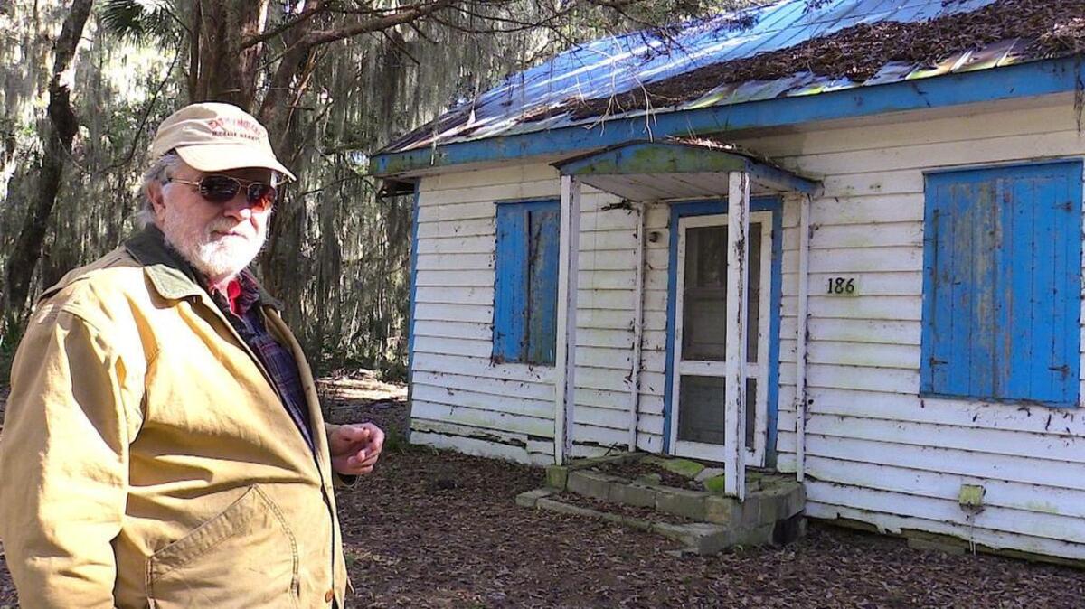 Roger Pinckney of Daufuskie Island points out a home along Haig Point Road, with ‘haint’ blue trim. It’s a Gullah tradition to use the color to keep evil or ghosts out.