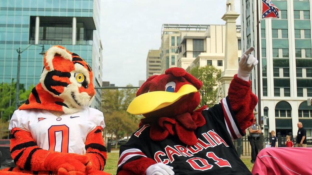 USC’s Cocky and Clemson’s Tiger, shown here at an earlier event promoting reading, will appear Saturday at StoryfestSC.