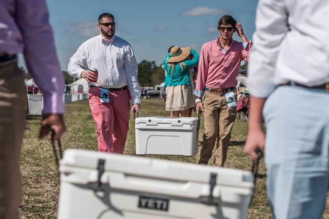 Joshua Raulerson and Hunter McManus of Lugoff haul their coolers through the infield at the Carolina Cup.