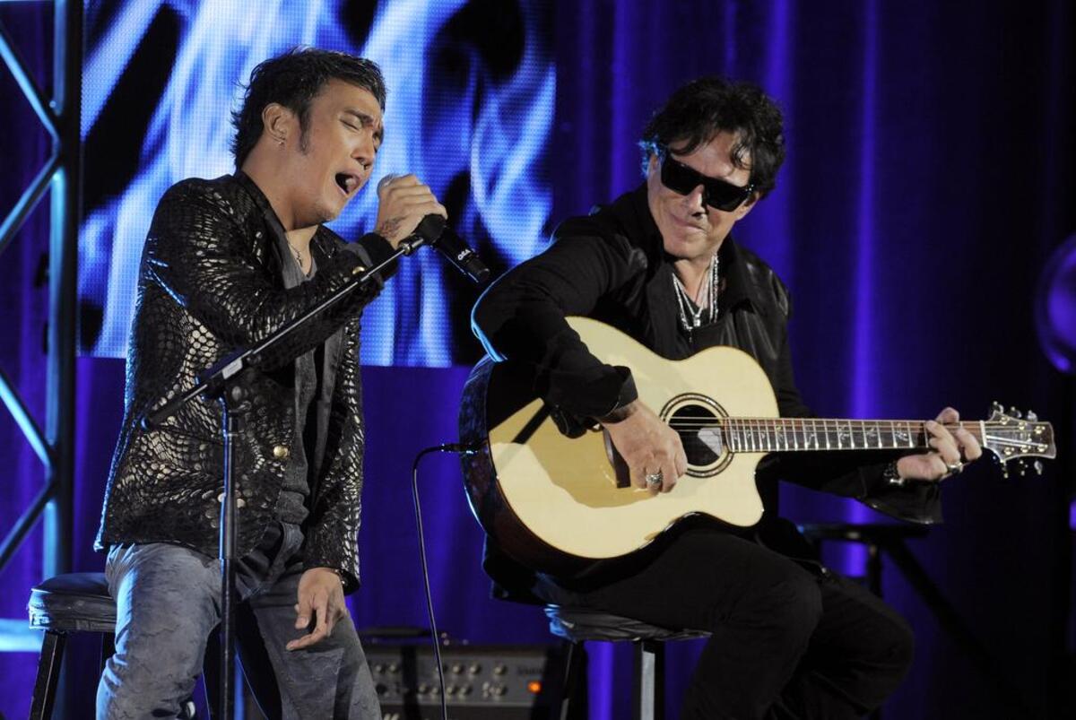 Arnel Pineda, left, and Neal Schon of the rock band Journey perform onstage. Journey and Def Leppard will perform at the PNC Arena in Raleigh June 5, 2018.