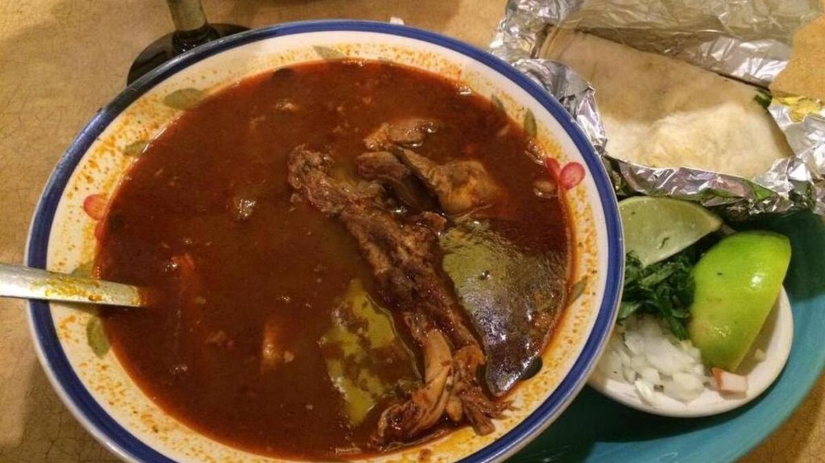 Birria, goat stewed in red chile sauce and served with tortillas, onion, cilantro and lime at Real Mexico.