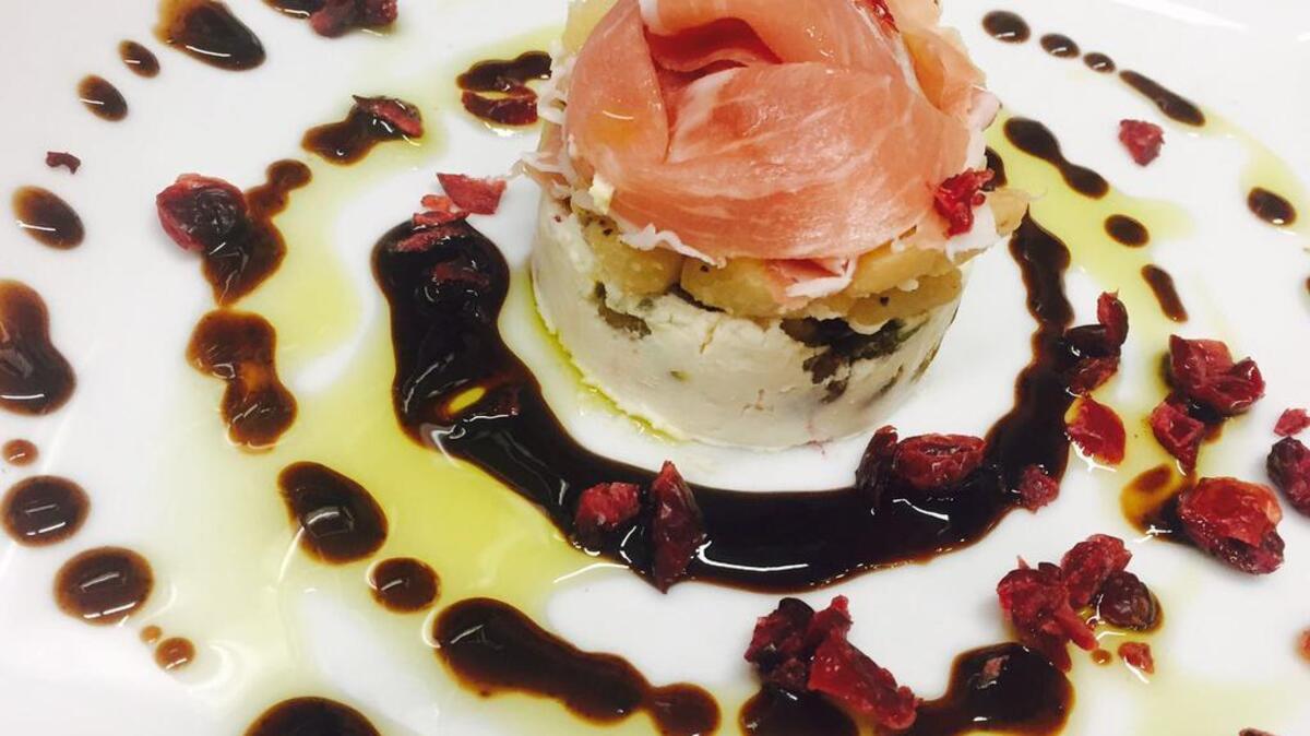 Creamy goat cheese with honey, pistachio nuts and cranberries, topped with sauteed Gala apples and prosciutto di parma, and served with an aged fig balsamic glaze.