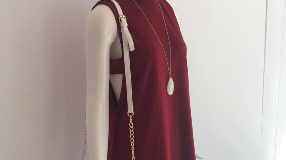 An outfit from Petal includes a side cutout dress ($48), clutch ($38) and necklace ($32).
