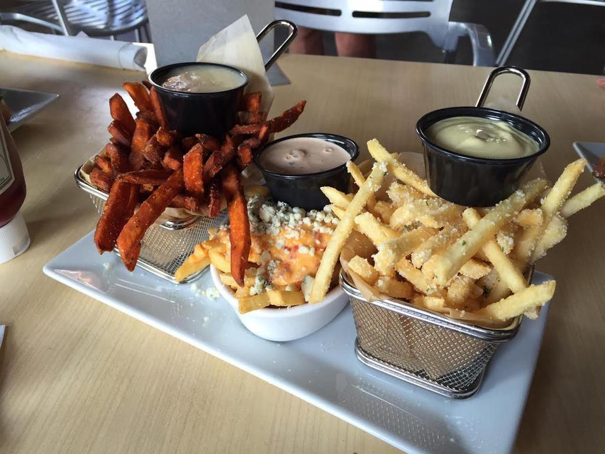 From left, sweet potato fries, bleu cheese + pimento cheese fries, and truffle Parmesan fries from Grill Marks