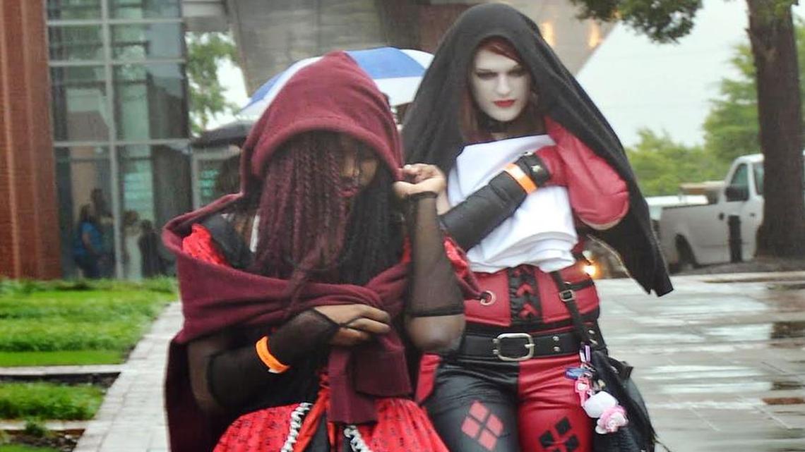 
Amiaya Glover, left, of West Columbia, dressed as a pirate girl while Megan Kiron, of Columbia, dressed as Batman adversary Harley Quinn, walk through the drizzle outside this weekend’s Soda City Comic Con.
