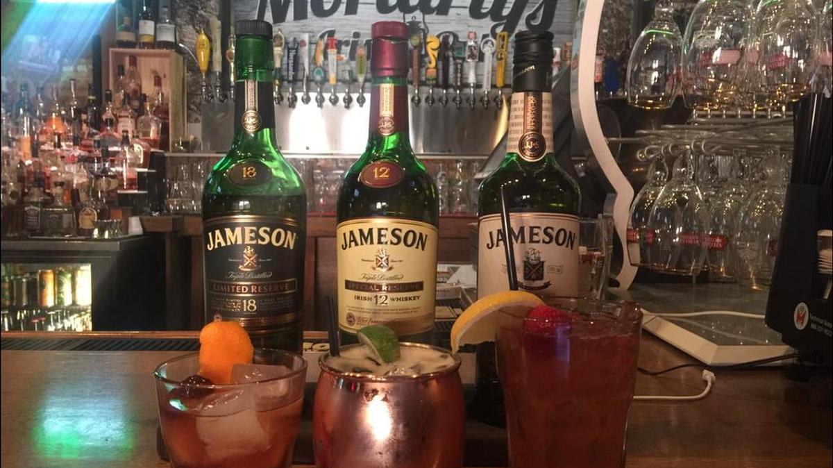 Moriarty’s Irish Pub offers a selection of Jameson Irish Whiskey, back, including Jameson 12 Year, center. The pub’s cocktails include a Jameson Black Barrel old-fashioned, a Jameson Black Barrel mule and the Irene Adler.