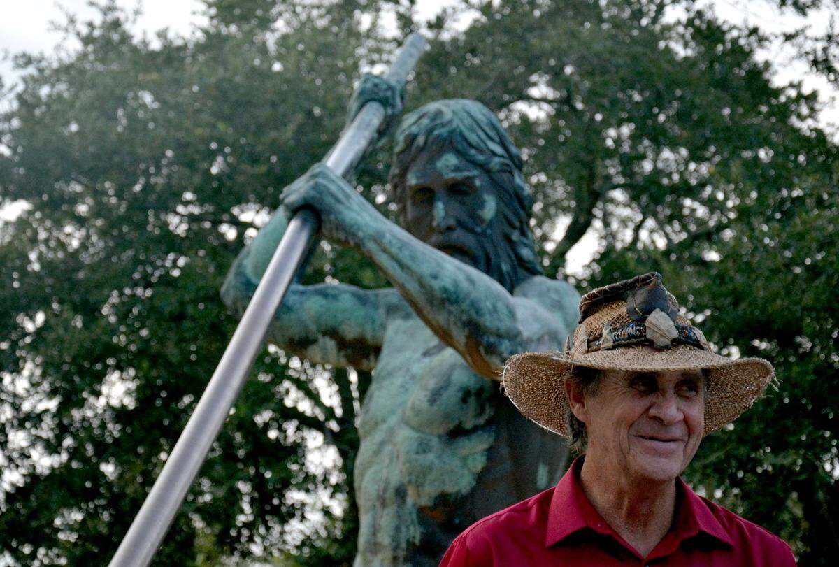 Bluffton artist Wayne Edwards stands next to his work, the King Neptune Statue and Sundial on Hilton Head Island.