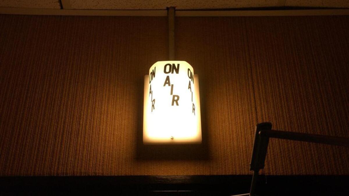 The On Air light lights up for one of the last times for the Under The Covers radio broadcast at WUSC. PHoto by Todd Bennett 7/30/03