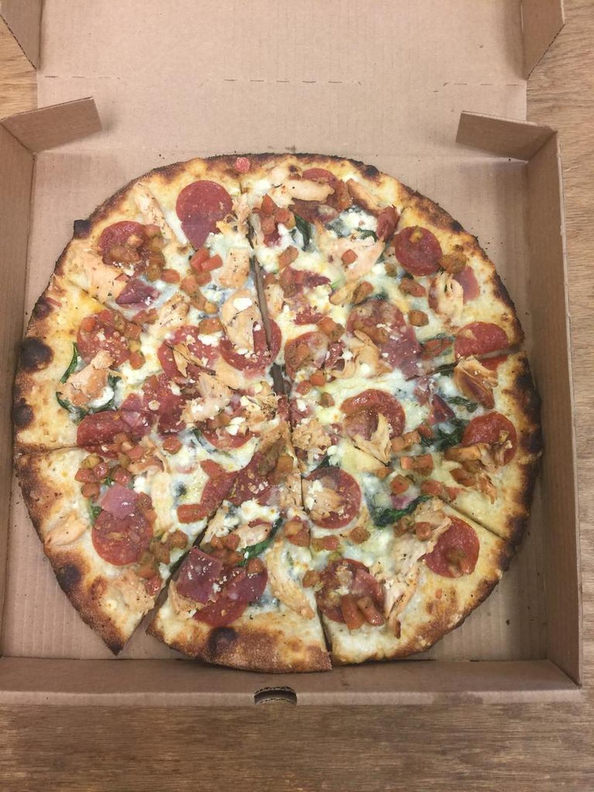 Za’s Brick Oven Pizza: Devine Pizza – chicken, Za’s white sauce, gruyere, feta, spinach, pepperoni, prosciutto and bruschetta.