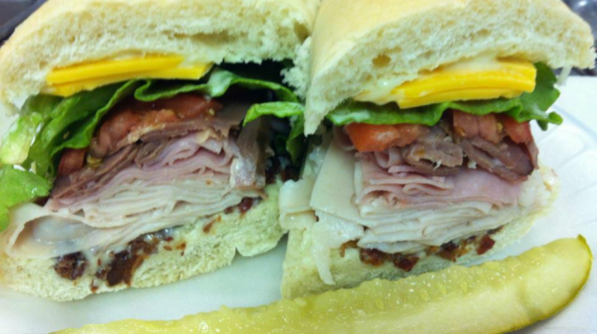 The Smokestack includes roast beef, turkey, ham, bacon, cheddar cheese, lettuce, tomato, and mayonnaise served cold on a hoagie roll or served hot with Thousand Island dressing on the side.