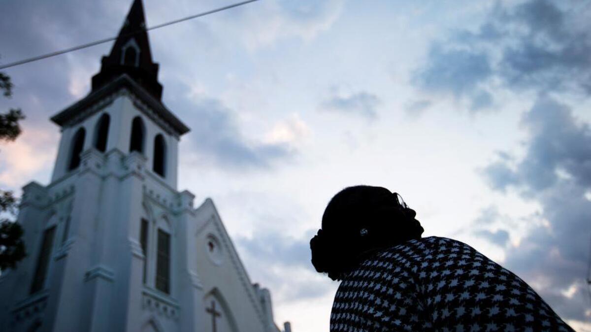 Doris Simmons, of Charleston, S.C. stands next to Emanuel AME Church.