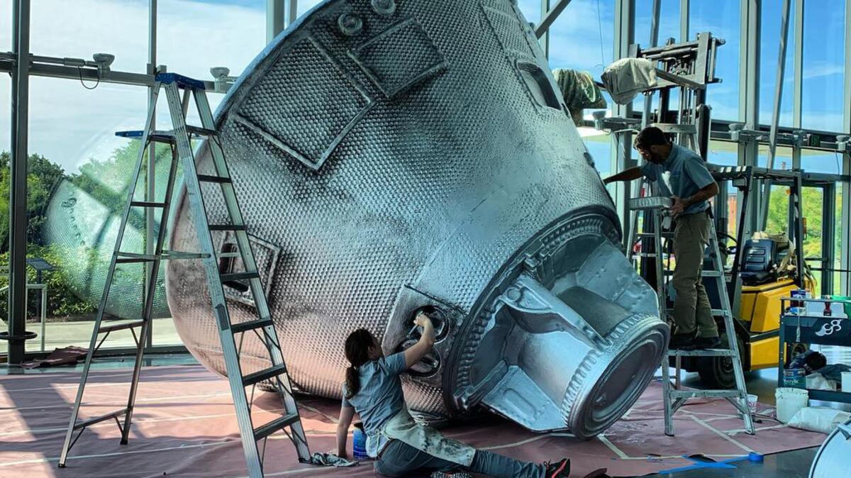 Teams work to create the Apollo 11 command module replica.