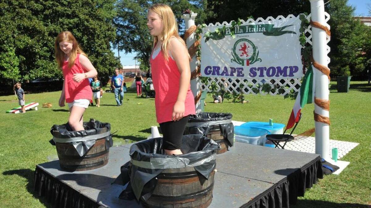 
Festivalgoers smash grapes during last year’s Italian Festival. 
