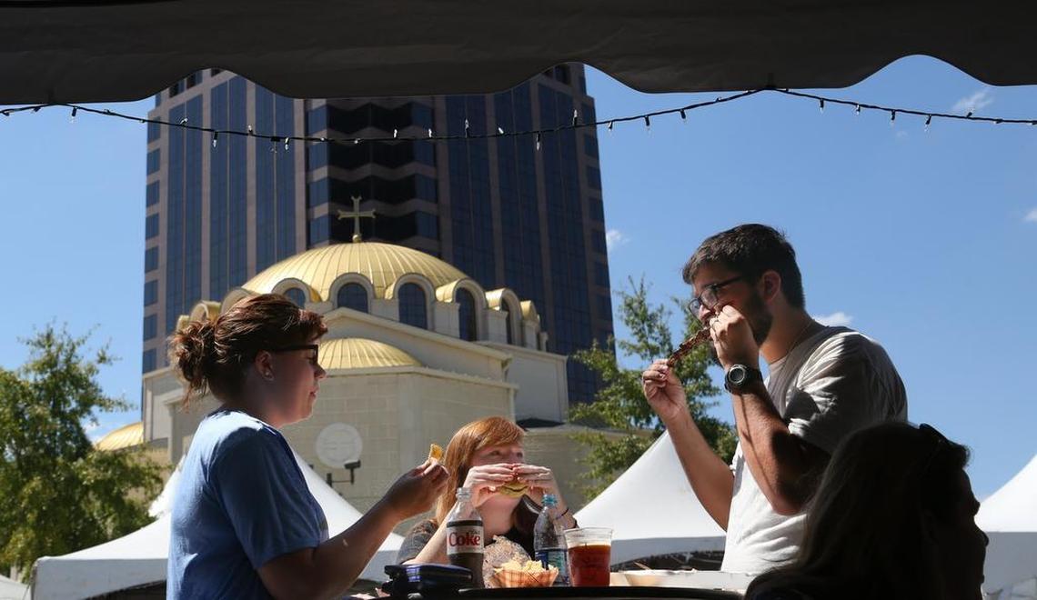 A trio dine on traditional Greek food during a past Greek Festival.
