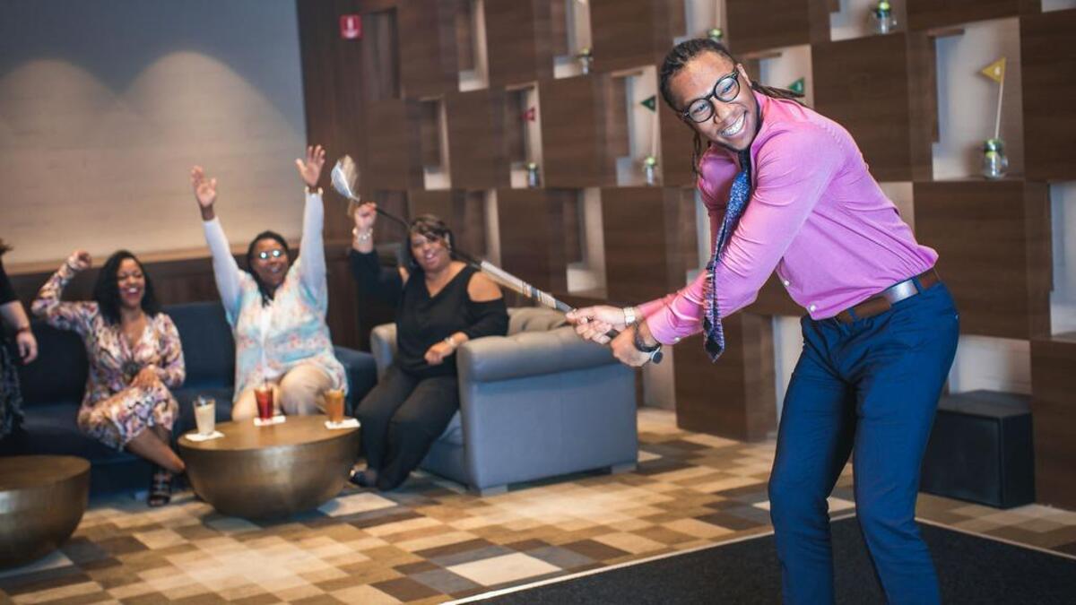 A lively game of golf at TopGolf Swing Suite in the Venue on Main Street.