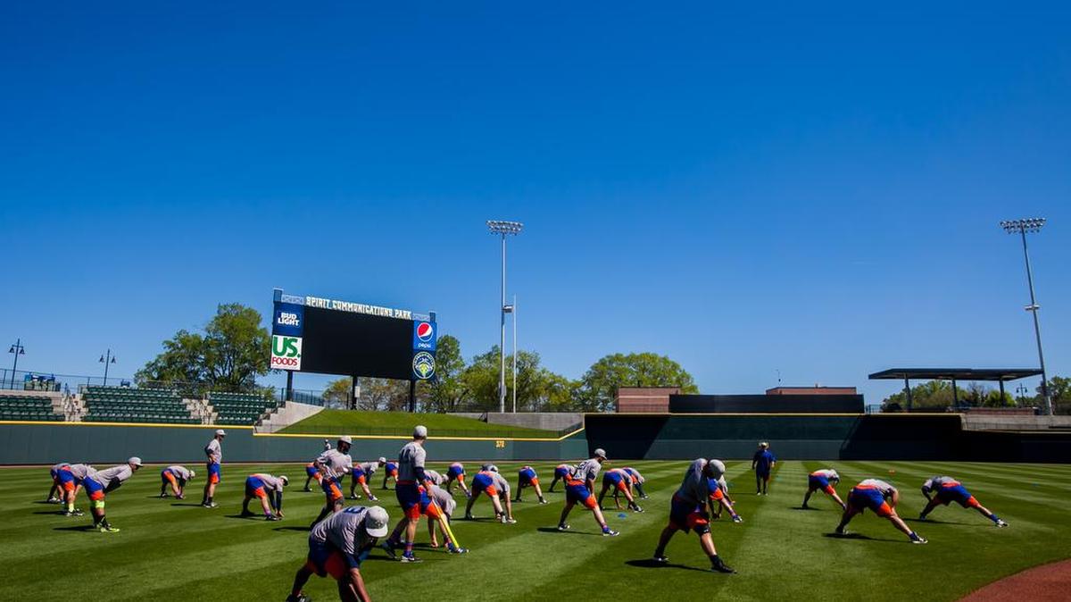 Fireflies players stretch at Spirit Communications Park during their first practice.