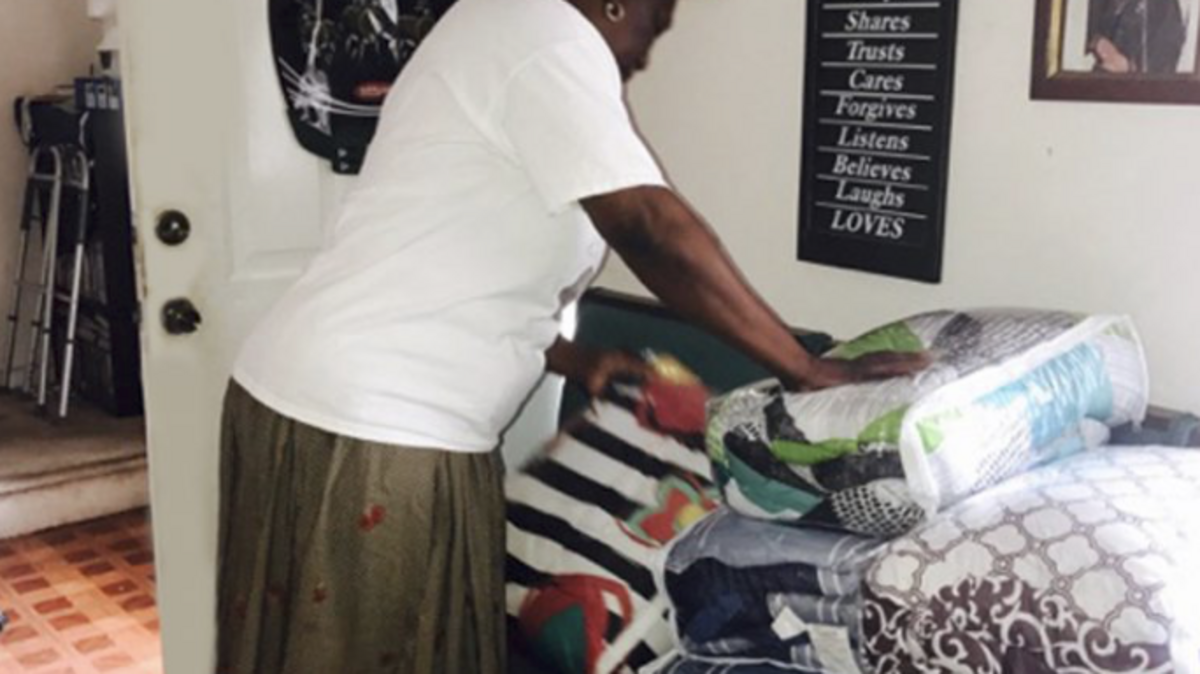 A volunteer folding blankets at Blanketing Families
