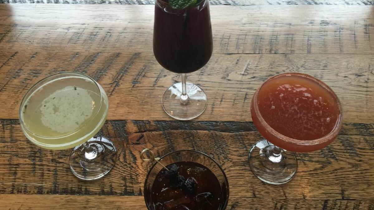 The Oak Table specialty cocktails include, clockwise from top, seasonal sangria, Legend of the Fall, Hoodoo Manhattan and Double Standard.