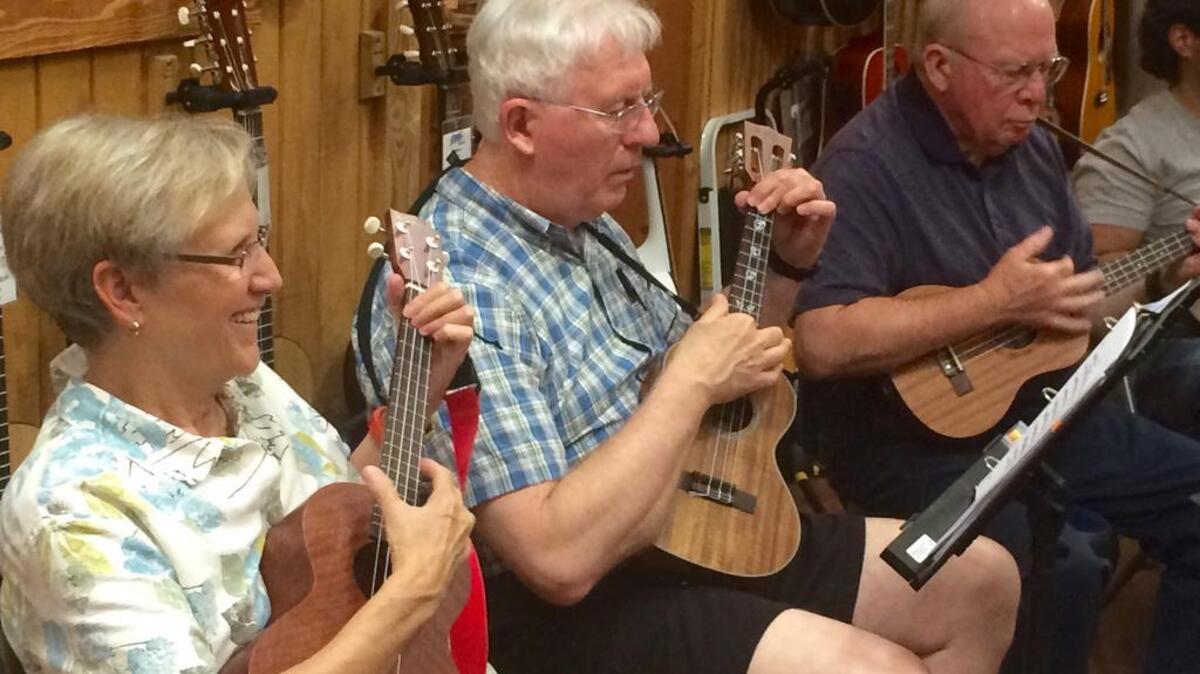 Members of the Cola Ukulele Band practice on a recent Tuesday at Sim’s Music in Irmo.