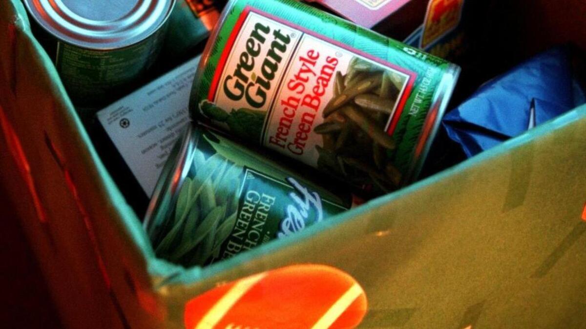 Cans and boxes of non-perishable food fill a box decorated with footballs at a Columbia area church at a past Souper Bowl of Sunday event.