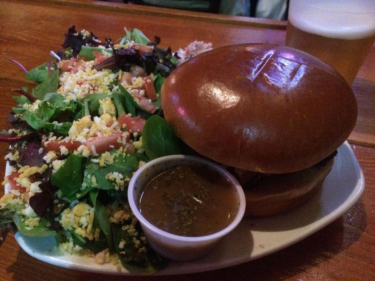 Burnt-ends sandwich with a house salad and coleslaw from Jake’s in Five Points.