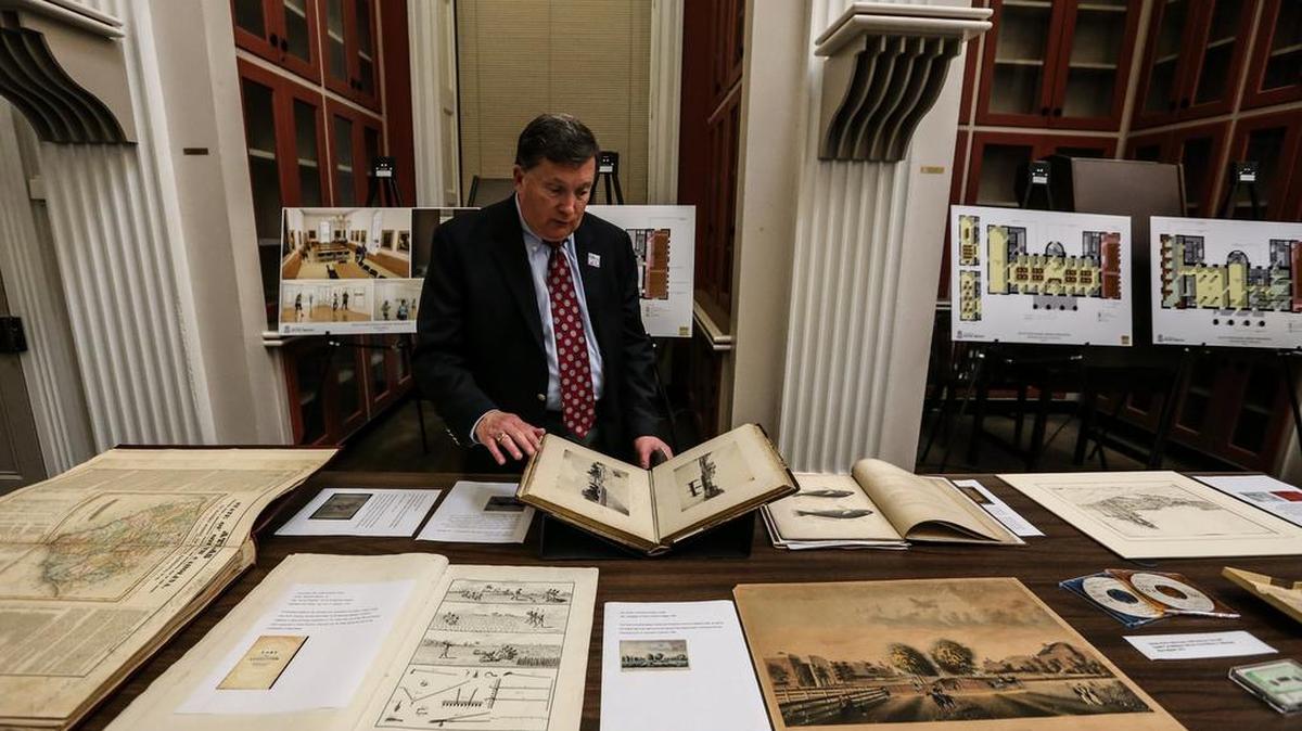 Director Henry Fulmer displays a book of photographs made before the Civil War at South Caroliniana Library, the oldest freestanding academic library in the country.