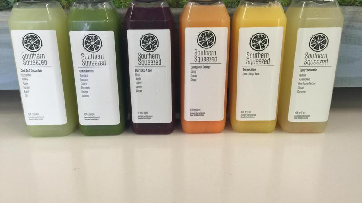 Katie and Saket Munshaw of Southern Squeezed offer free samples before customers buy a bottle of cold-pressed juice.