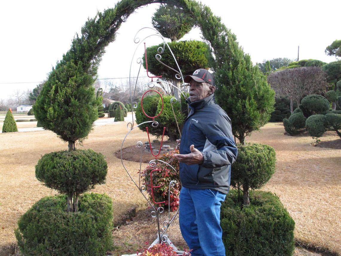 In this Dec. 11, 2014 photo, Pearl Fryar talks about one of many sculptures in his famous topiary garden in Bishopville.
