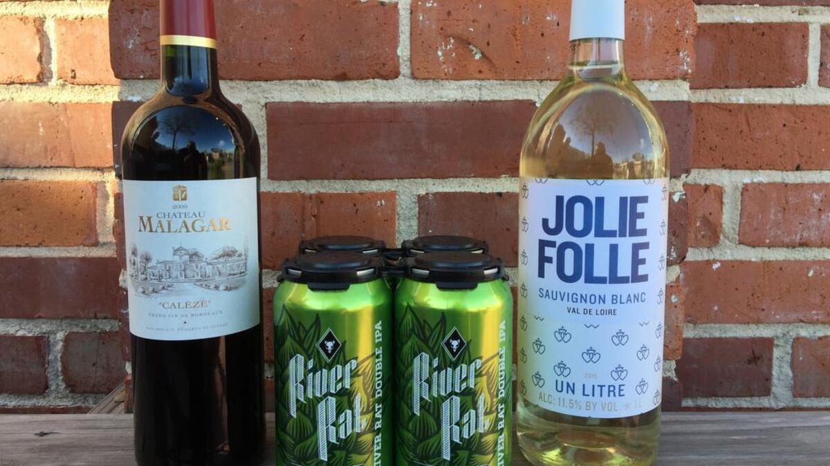 A sample of wine and beer available at The Vino Garage includes, from left, Chateau Malagar Cuvee Caleze Bordeaux, River Rat Double IPA and Jolie Folle sauvignon blanc.