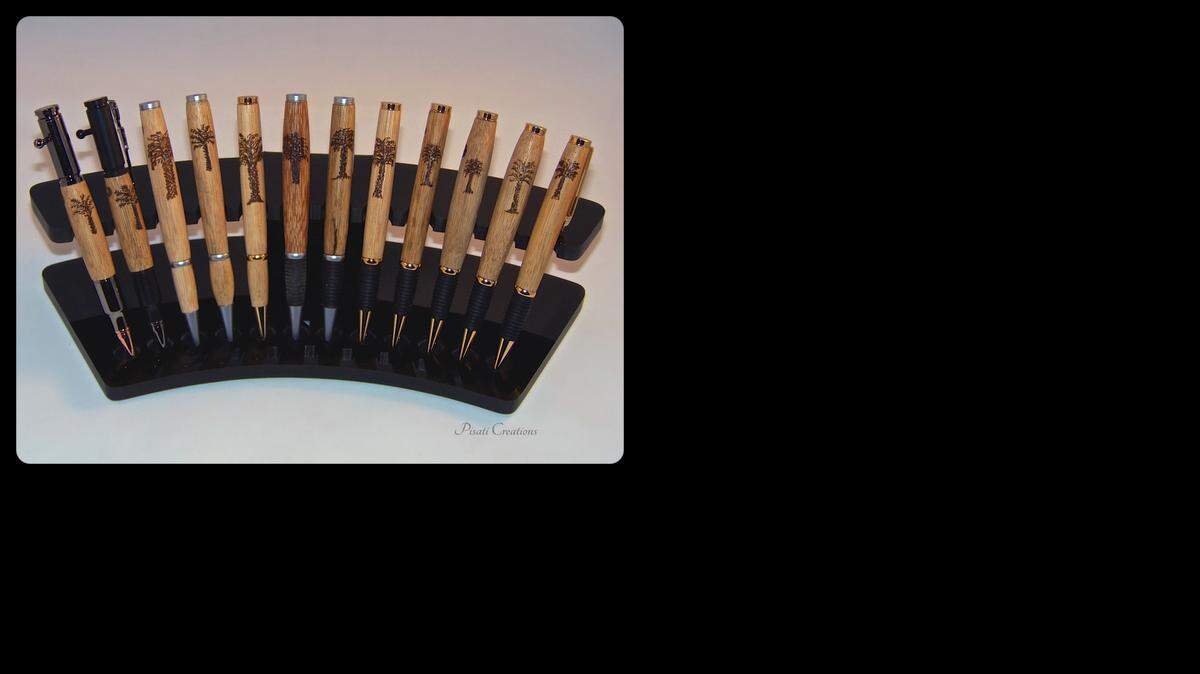 
Using a lathe and a wood-burning tool, woodworkers Katherine and John Sakovich of Pisati Creations transform the hard cores of Palmetto wood into elegant wood-like pens inscribed with a Palmetto tree.
