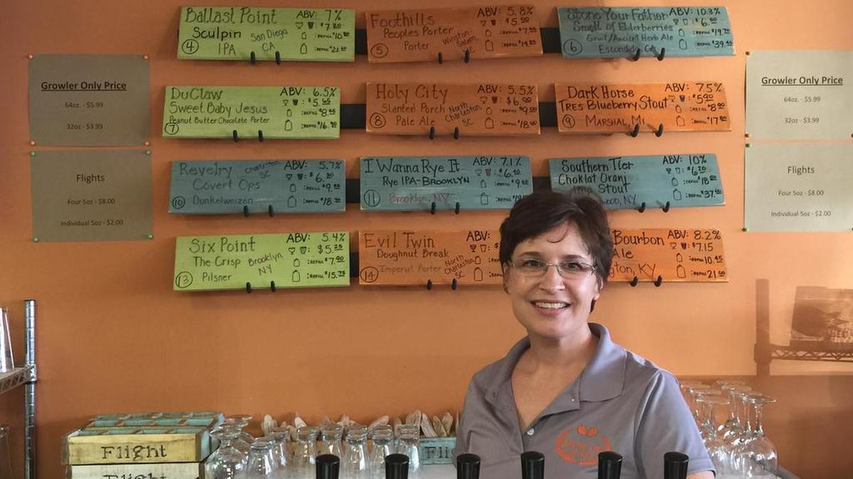 Kimberly Gagliardi stands behind the bar at Random Tap, which and her husband recently opened.