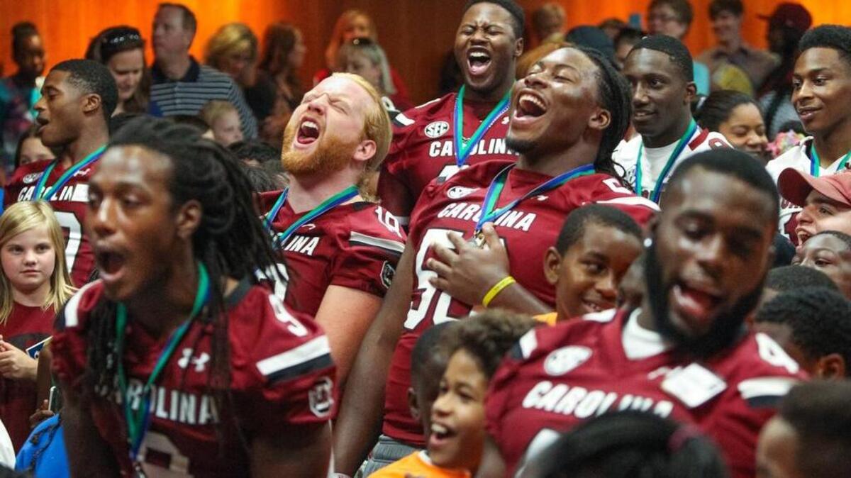 Some University of South Carolina players get loud with kids attending last year’s Pigskin Poets. The annual event promotes reading.