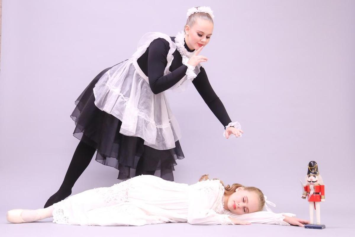 Clara (Bridie Castell) and the Maid (Nora Castell) appear in a scene from Ann Brodie’s Carolina Ballet’s production of “The Nutcracker.”