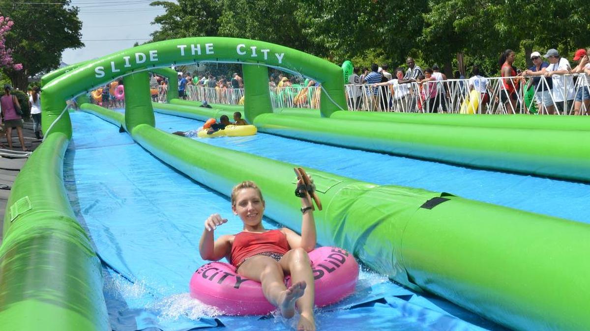 Having fun at last year’s Slide the City event in downtown Columbia.