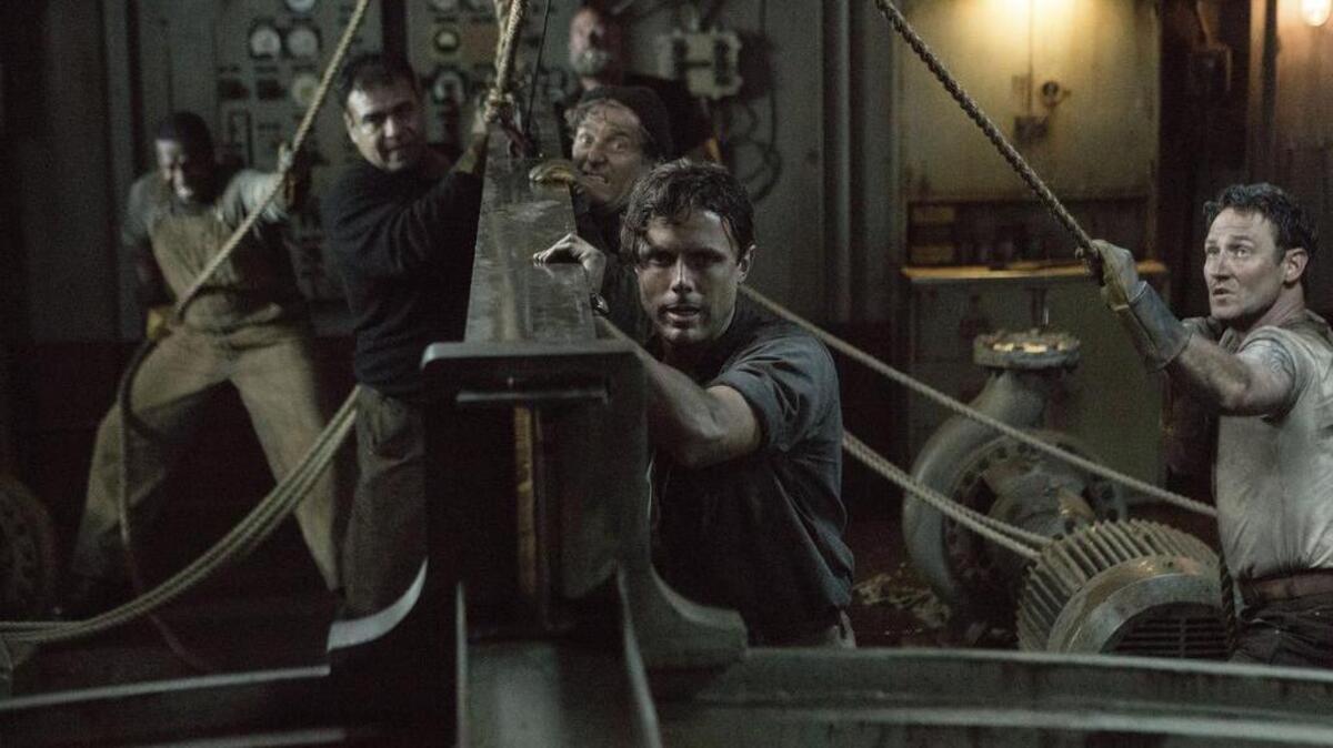 Ray Sybert (Casey Affleck) and Tchuda Southerland (Josh Stewart) struggle to keep their ship, the SS Pendleton, from sinking in “The Finest Hours.”