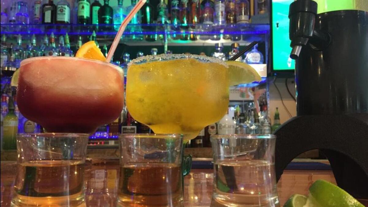 A menagerie of cinco de mayo drinks (l to r): the “sangrita swirl”, the jalapeño mango margarita, a house margarita tower and a flight of tequilas