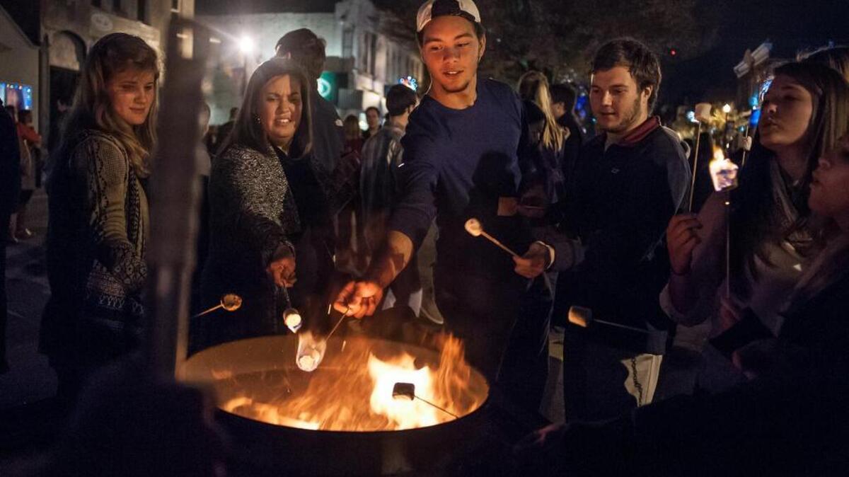 Vista Lights 2015 participants roast marshmallows at the dining and shopping district’s annual open house.
